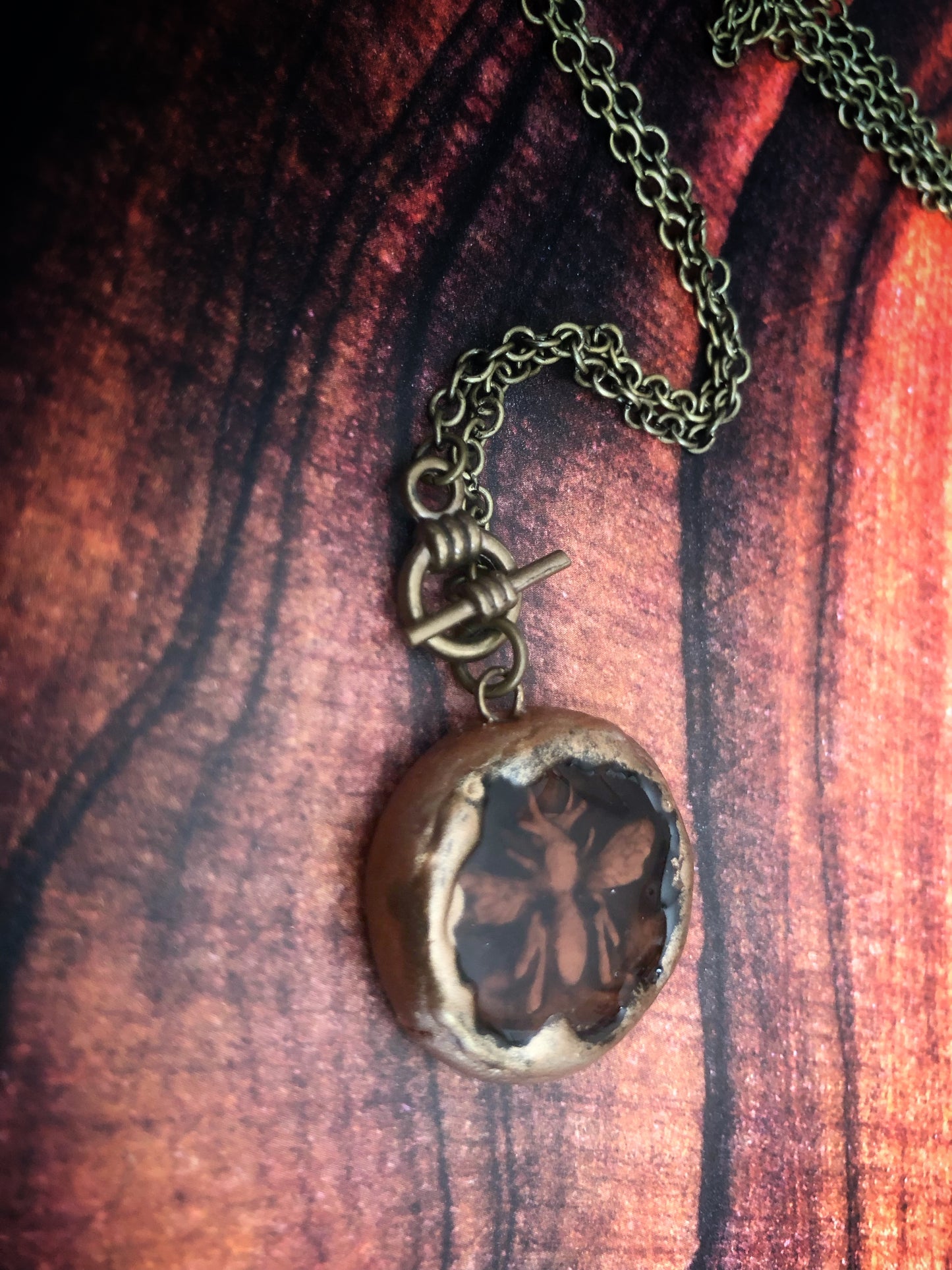 Hand Carved Clay Bee Encased in a Resin Seal Enhanced with Antique Gold
