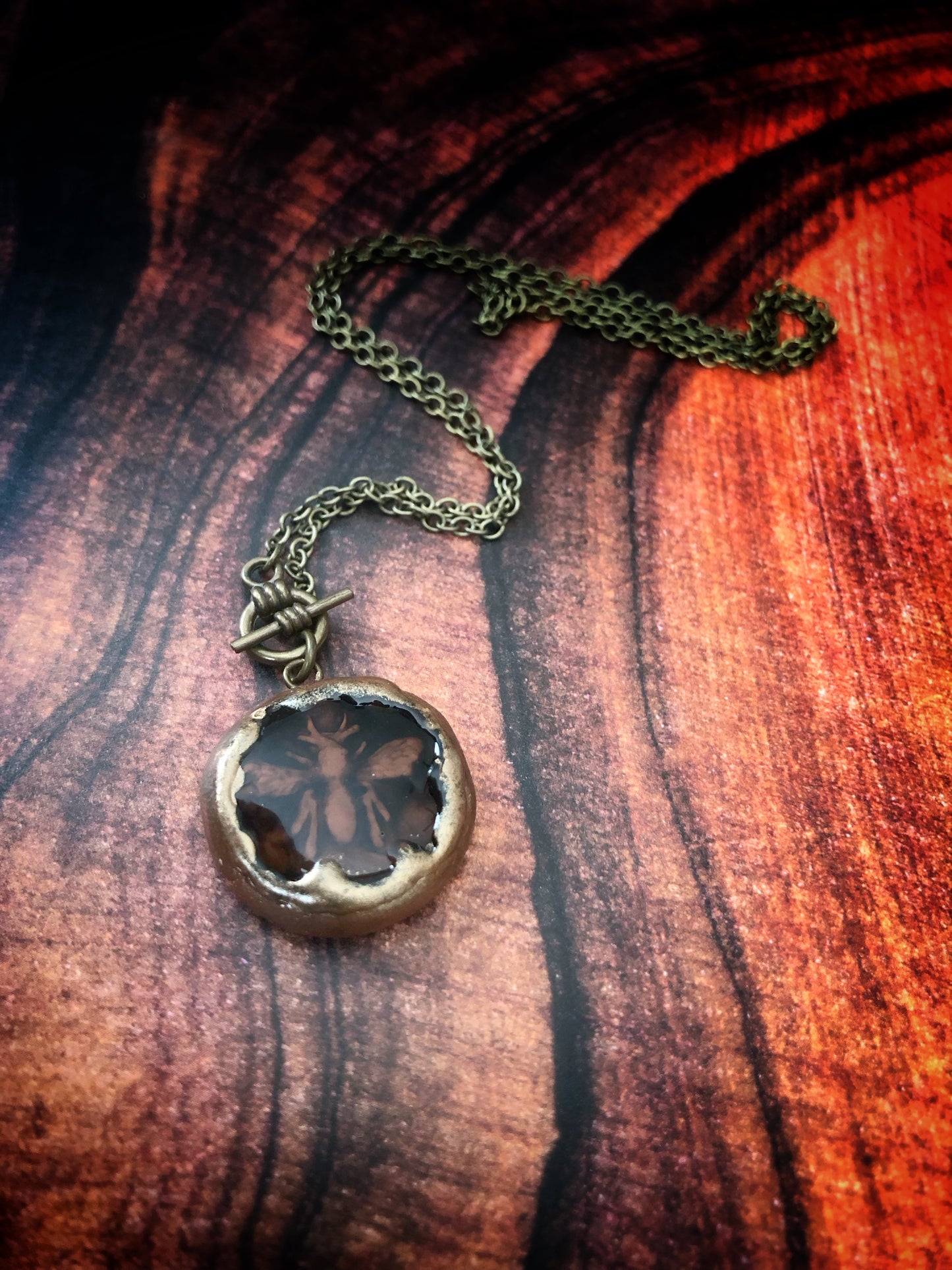 Hand Carved Clay Bee Encased in a Resin Seal Enhanced with Antique Gold