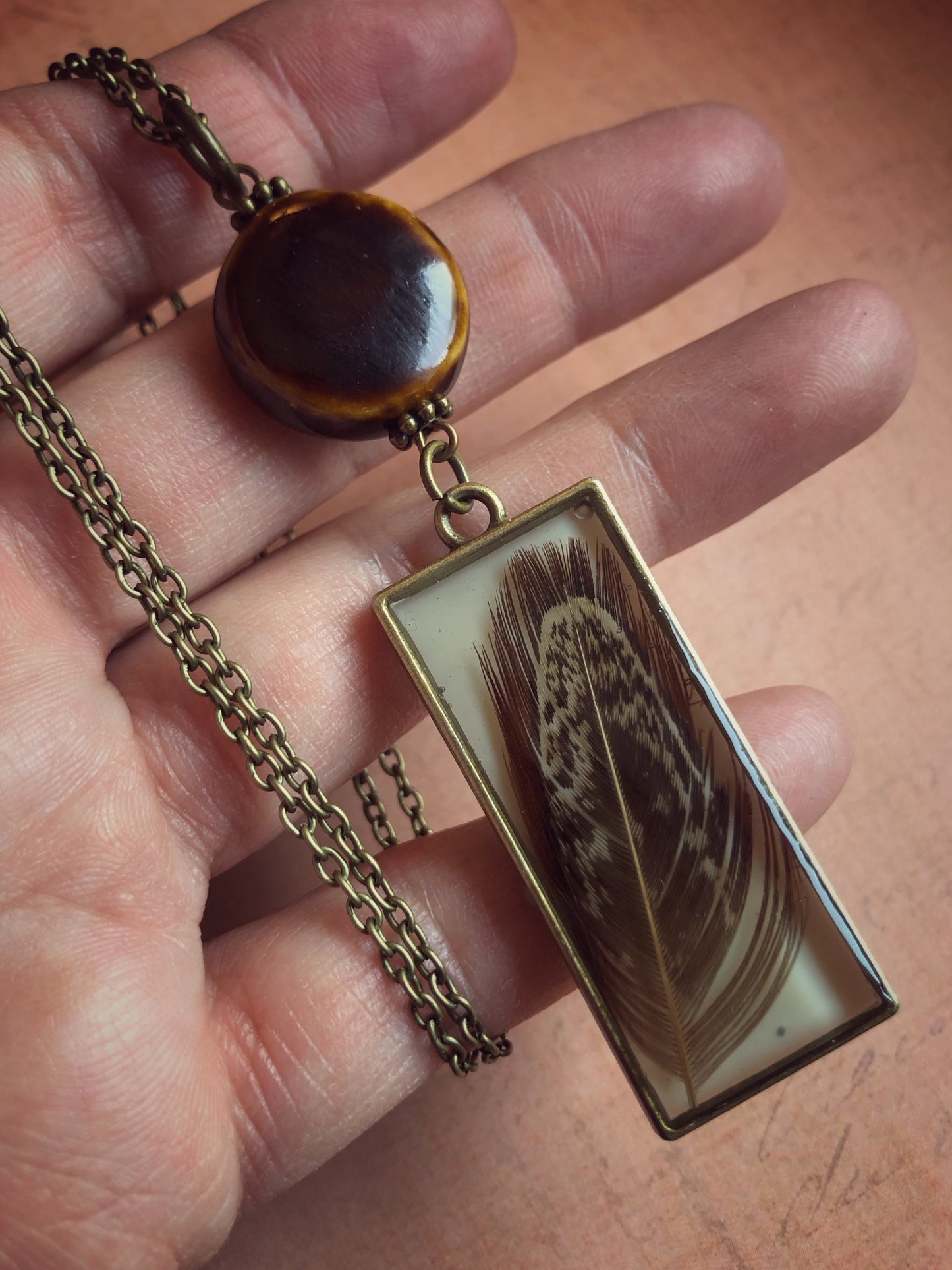 Long Necklace Brown Feather in Resin with Ceramic Bead on Antiqued Brass Chain