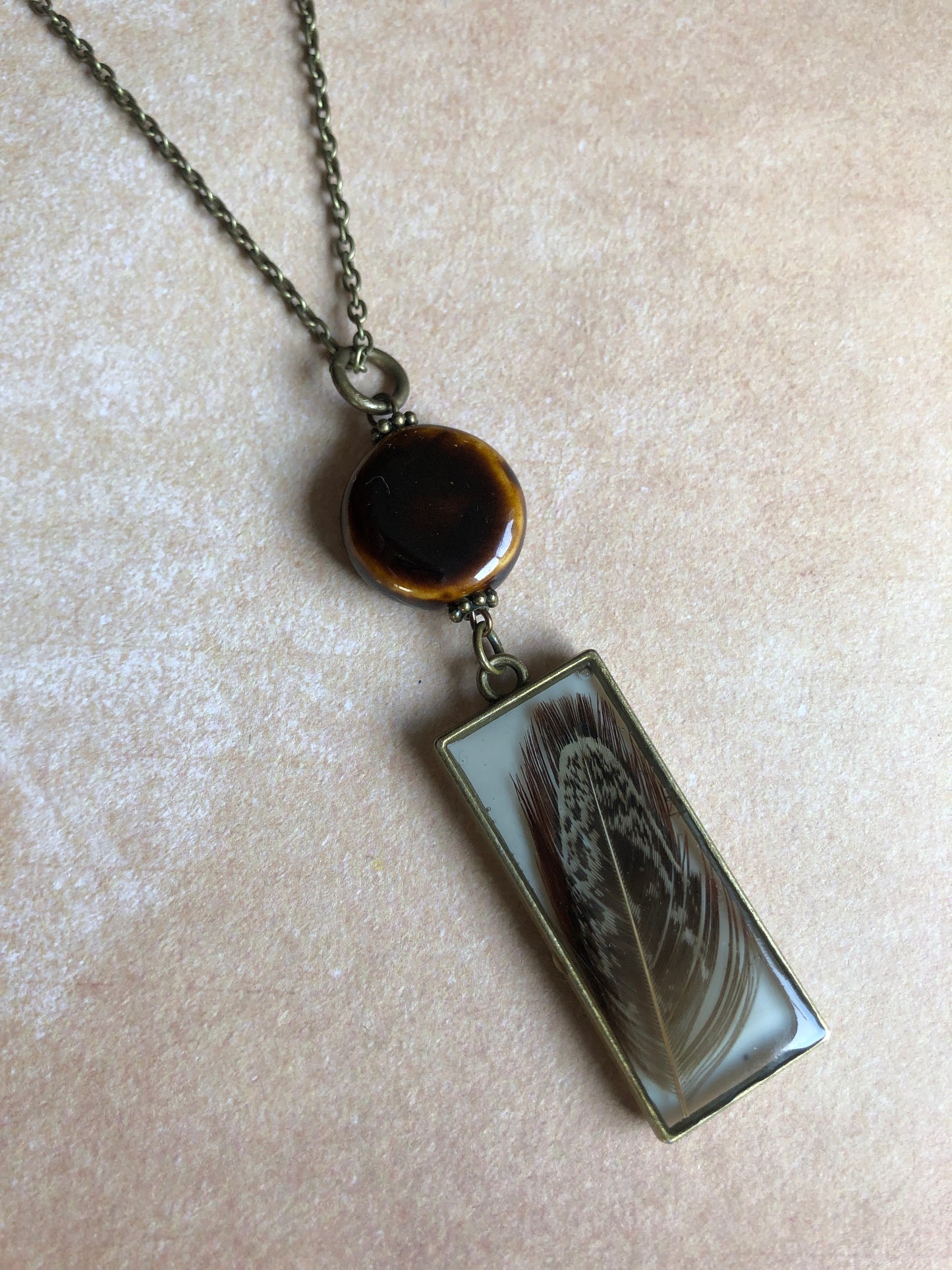 Long Necklace Brown Feather in Resin with Ceramic Bead on Antiqued Brass Chain