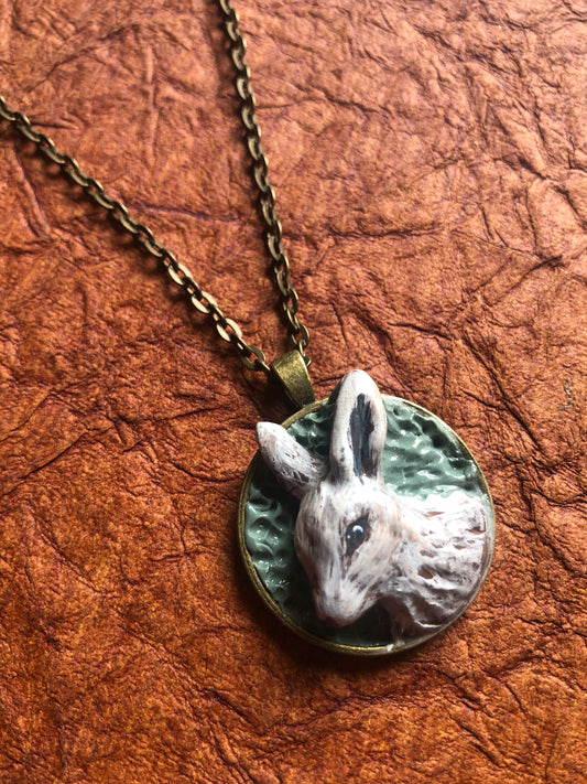 Hand Carved Clay Rabbit in 1.25” Antiqued Brass Setting with Coordinating Chain