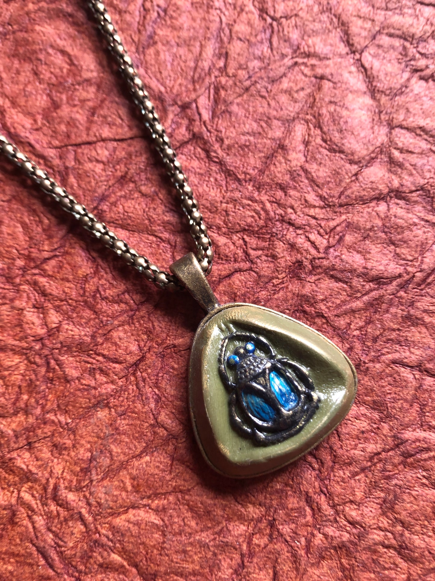 Hand Painted Clay Beetle Cabochon Pendant in 1” Triangle Setting Hung on an 19" Antiqued Brass Snake Chain