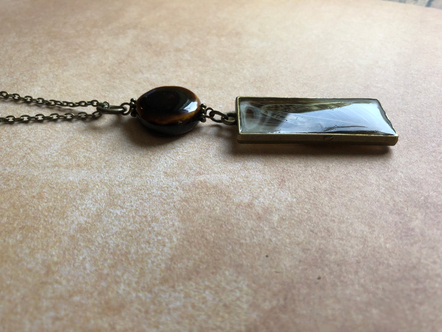 Long Necklace Brown Feather in Resin with Ceramic Bead on Antiqued Brass Chain