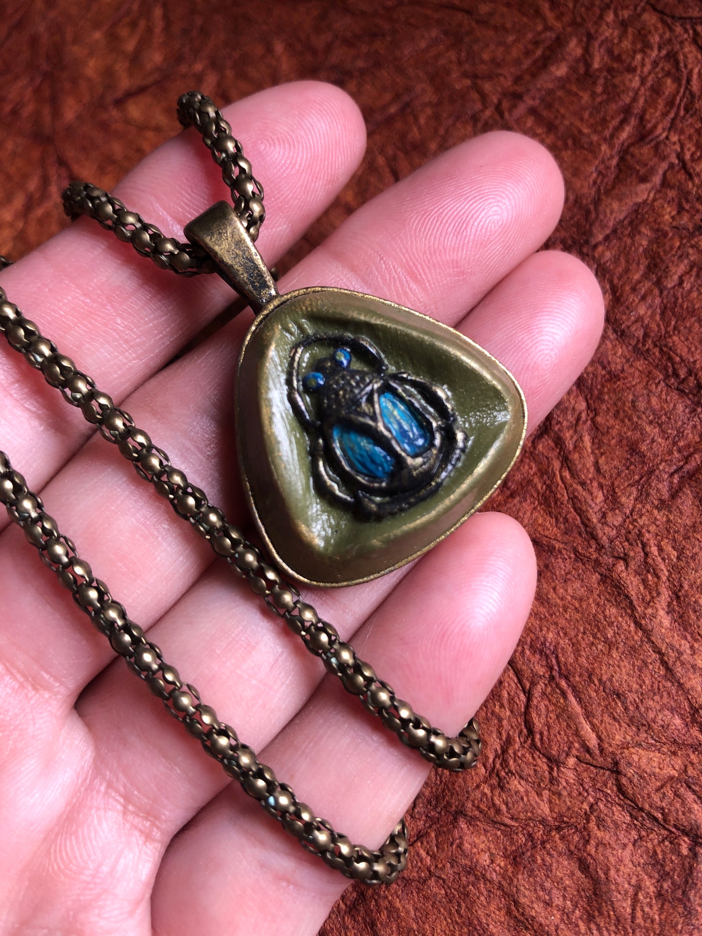 Hand Painted Clay Beetle Cabochon Pendant in 1” Triangle Setting Hung on an 19" Antiqued Brass Snake Chain