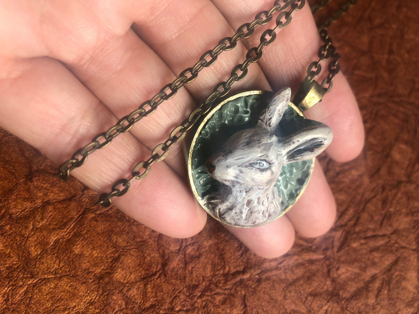 Hand Carved Clay Rabbit in 1.25” Antiqued Brass Setting with Coordinating Chain